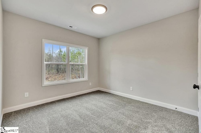 unfurnished room featuring carpet floors, baseboards, and visible vents