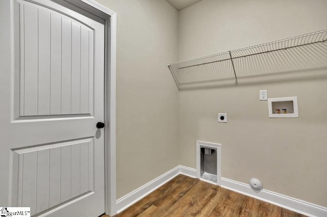 laundry room with hookup for a washing machine, dark wood-type flooring, electric dryer hookup, laundry area, and baseboards