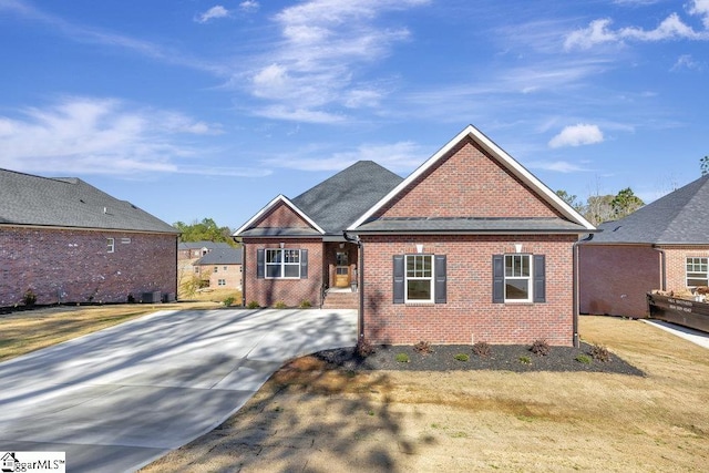 traditional-style home featuring brick siding and a front lawn