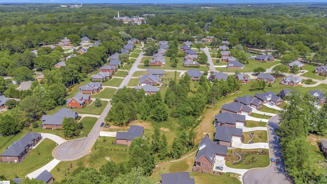 birds eye view of property featuring a forest view and a residential view