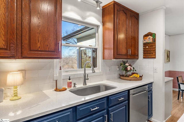 kitchen featuring decorative backsplash, a sink, light stone counters, and dishwasher