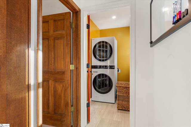 washroom with stacked washer / dryer and laundry area