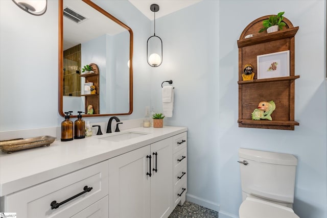 bathroom with baseboards, visible vents, vanity, and toilet