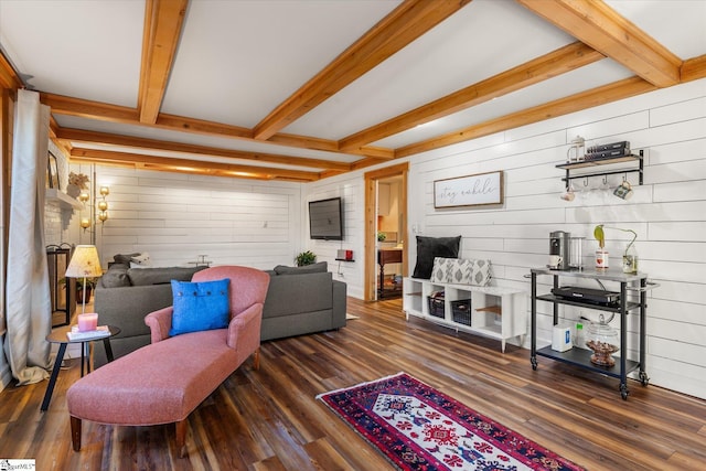 living room featuring dark wood-type flooring, beam ceiling, and wooden walls