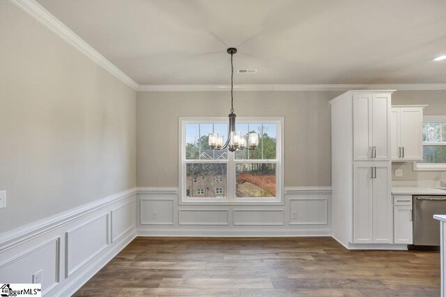 120 Bonaire Pt, Anderson, SC 29621 - unfurnished dining area with visible vents, wainscoting, wood finished floors, an inviting chandelier, and crown molding