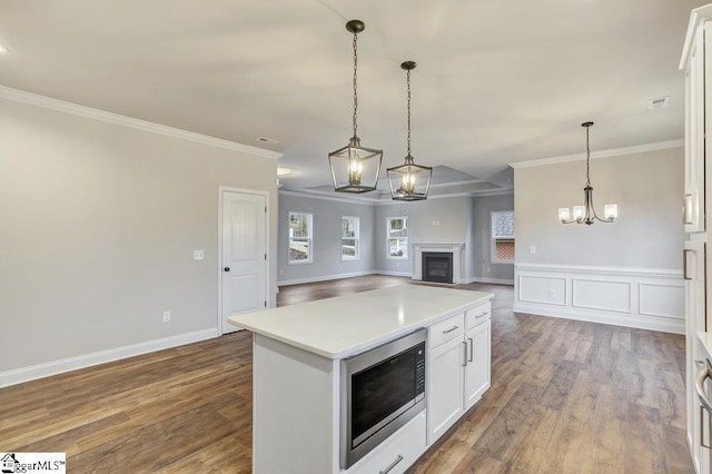 120 Bonaire Pt, Anderson, SC 29621 - kitchen featuring a kitchen island, white cabinetry, open floor plan, light countertops, and built in microwave