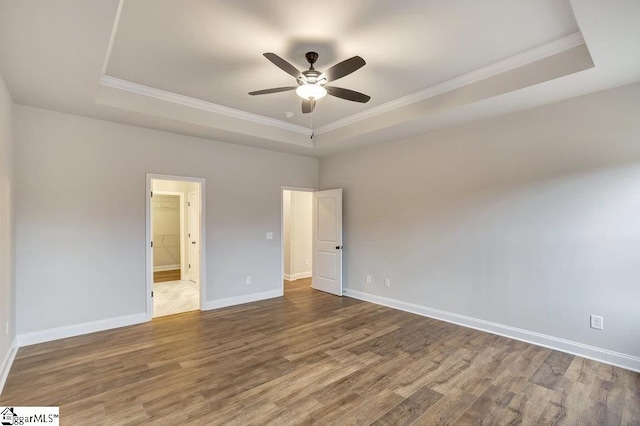 120 Bonaire Pt, Anderson, SC 29621 - unfurnished bedroom featuring crown molding, a tray ceiling, wood finished floors, and baseboards