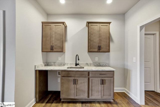 120 Bonaire Pt, Anderson, SC 29621 - kitchen featuring dark wood finished floors, recessed lighting, a sink, light stone countertops, and baseboards
