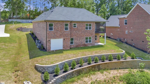 120 Bonaire Pt, Anderson, SC 29621 - rear view of house with a garage, a yard, a sunroom, and brick siding