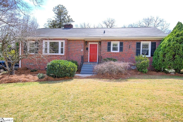 single story home with brick siding, a chimney, and a front lawn