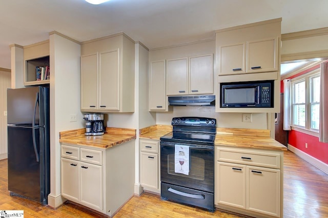 kitchen with black appliances, light wood-type flooring, wood counters, and under cabinet range hood