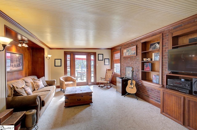 living room featuring ornamental molding, light carpet, wood walls, and built in shelves