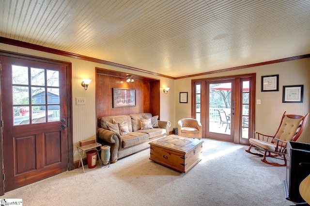 living area featuring light carpet and crown molding