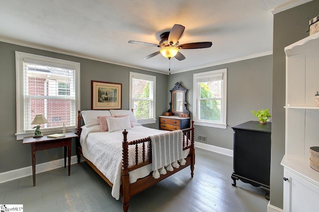 bedroom featuring baseboards, dark wood-type flooring, visible vents, and crown molding