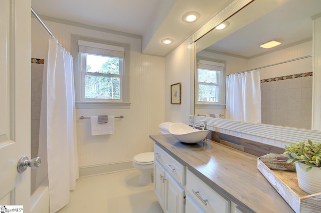 bathroom featuring toilet, vanity, and shower / bathtub combination with curtain