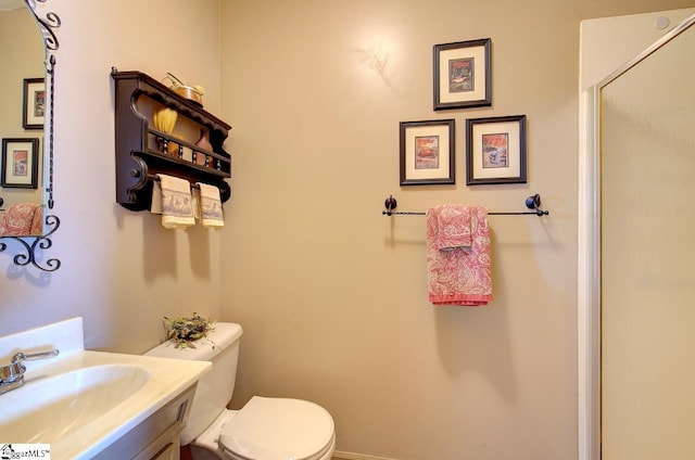 bathroom featuring toilet and vanity