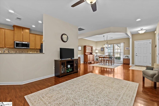 living area with recessed lighting, visible vents, dark wood finished floors, and ceiling fan with notable chandelier