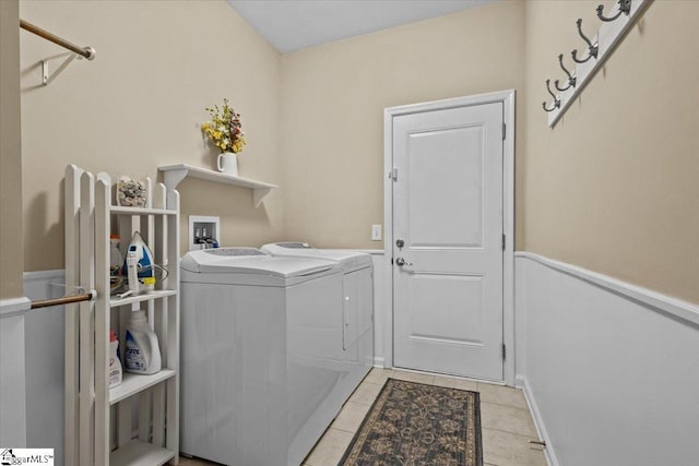 laundry area with laundry area, light tile patterned flooring, and washer and dryer