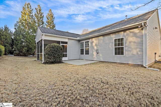 rear view of house featuring a yard, a patio area, and a sunroom