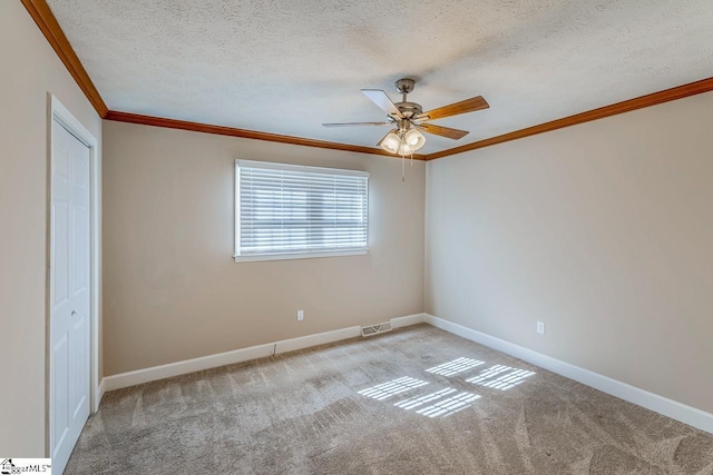 unfurnished bedroom with baseboards, visible vents, crown molding, and light colored carpet