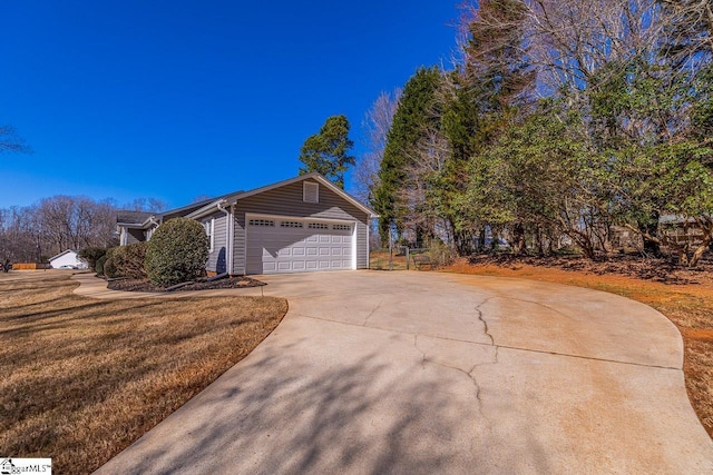 view of home's exterior with driveway, an attached garage, and a lawn