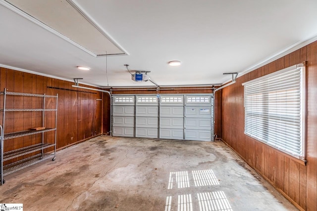 garage featuring wood walls and a garage door opener