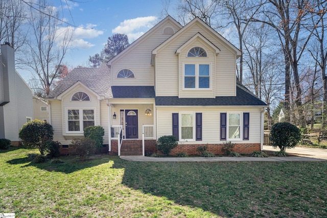 traditional-style house featuring a shingled roof, crawl space, and a front yard