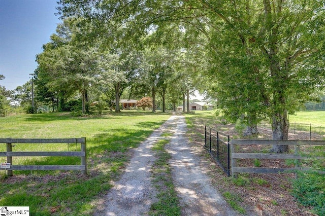 view of road with driveway and a gated entry