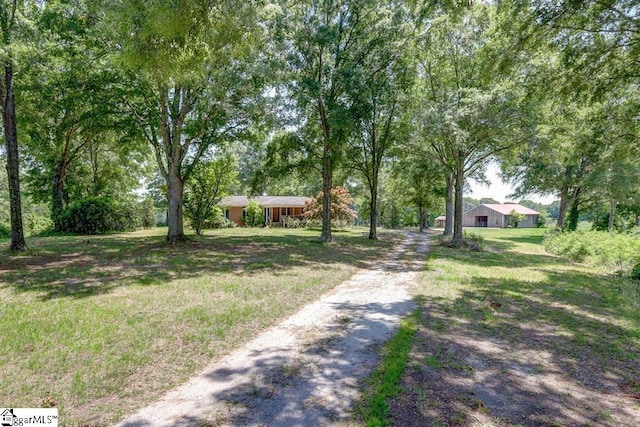 exterior space featuring driveway and a front lawn