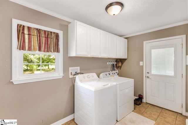 washroom featuring light tile patterned floors, cabinet space, ornamental molding, washer and dryer, and baseboards