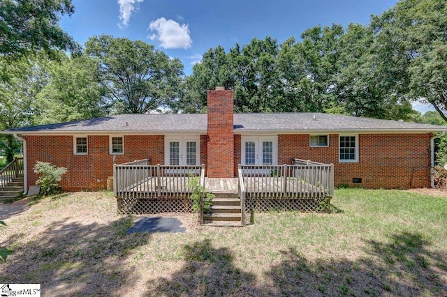 back of house with crawl space, a chimney, a deck, and brick siding