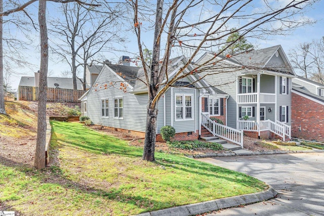 view of front of house with crawl space, a chimney, and a front lawn