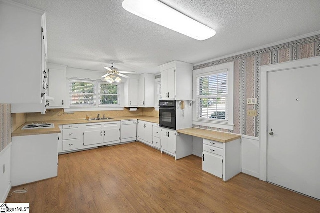 kitchen with light countertops, white appliances, white cabinets, and a healthy amount of sunlight