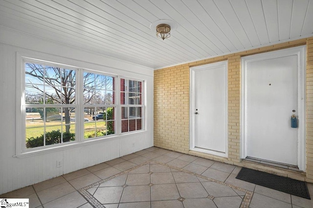 unfurnished sunroom featuring wood ceiling