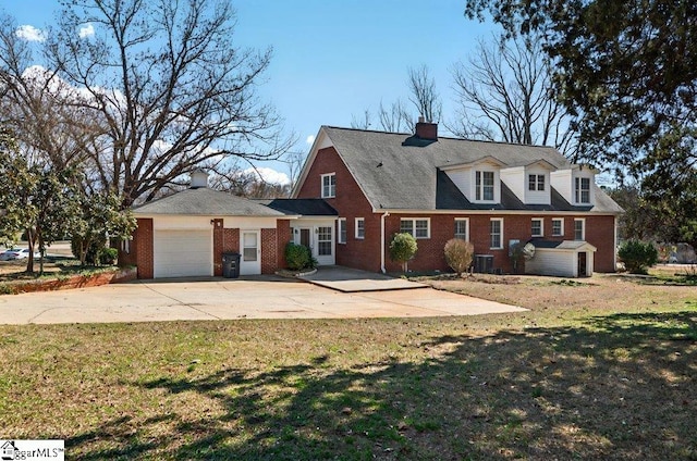 cape cod house featuring brick siding, concrete driveway, a front yard, a garage, and cooling unit