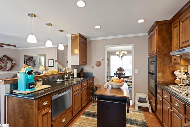 kitchen featuring a kitchen island, brown cabinets, and a sink