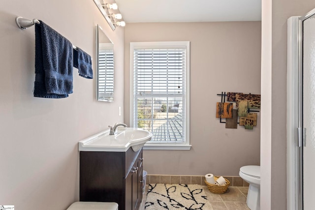 bathroom featuring toilet, tile patterned flooring, vanity, and baseboards