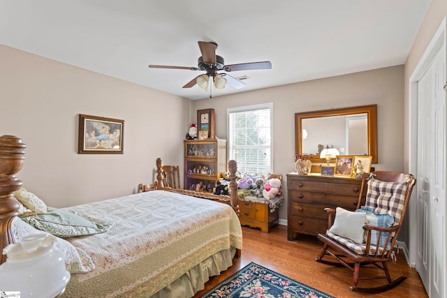 bedroom featuring ceiling fan, a closet, and wood finished floors