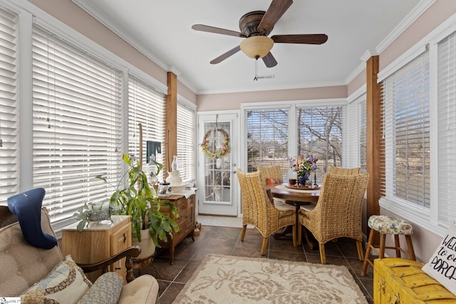 sunroom / solarium featuring visible vents and a ceiling fan