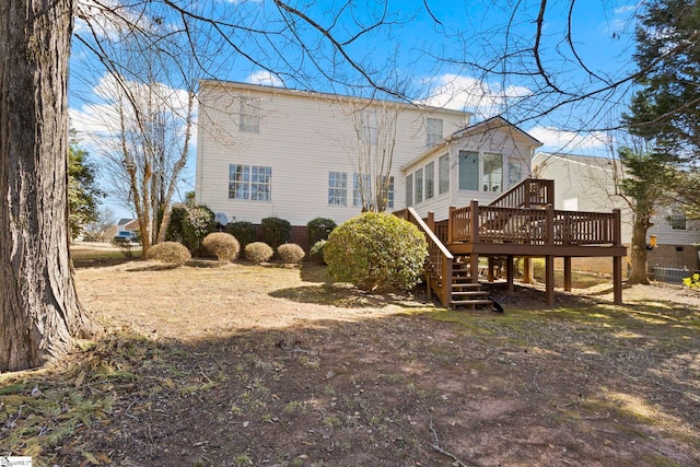 rear view of house with stairway and a wooden deck