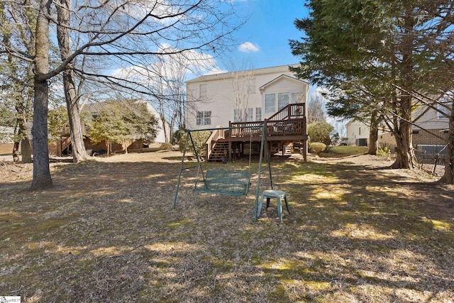 back of house with a yard, stairway, and a wooden deck