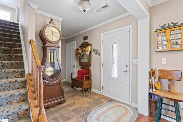 foyer entrance featuring stairs, ornamental molding, visible vents, and baseboards