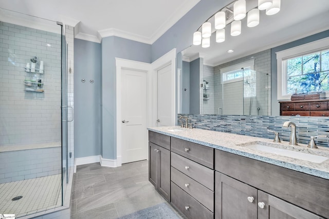 bathroom with a stall shower, crown molding, backsplash, and a sink