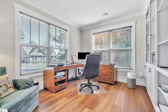 office featuring ornamental molding, visible vents, light wood-style flooring, and baseboards