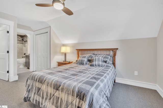 carpeted bedroom featuring baseboards, a ceiling fan, ensuite bathroom, vaulted ceiling, and a closet