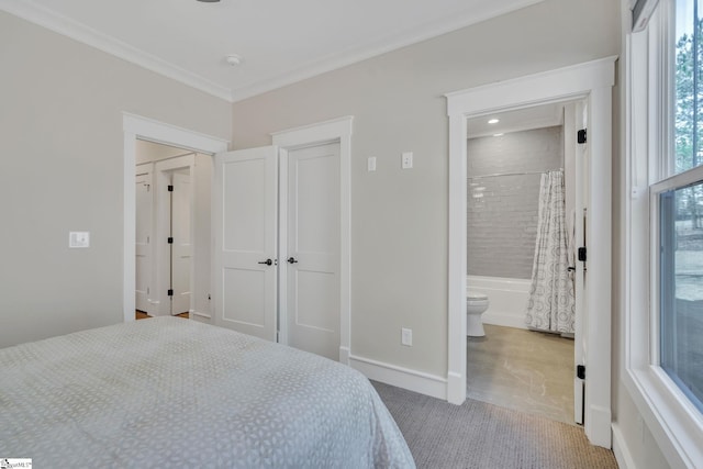 bedroom featuring baseboards, ornamental molding, and connected bathroom