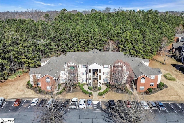 drone / aerial view featuring a wooded view