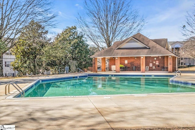 pool with fence and a patio