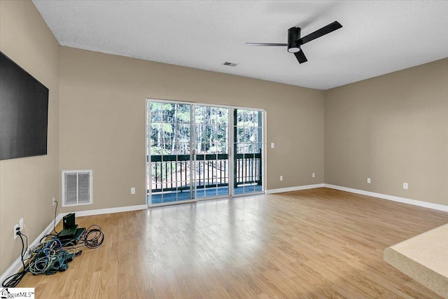 spare room with a ceiling fan, light wood-style flooring, visible vents, and baseboards