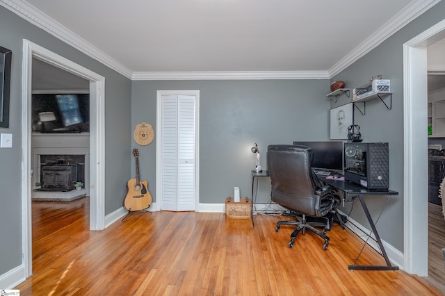 home office with crown molding, baseboards, and wood finished floors